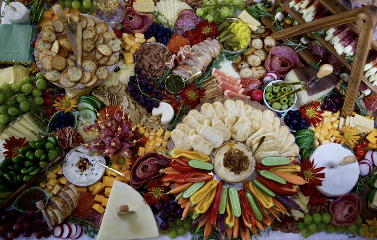 Hands styling a luxury grazing board